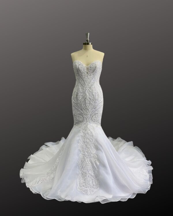 Gorgeous Ivory Heavy beaded lace mermaid wedding dress with a dark background.